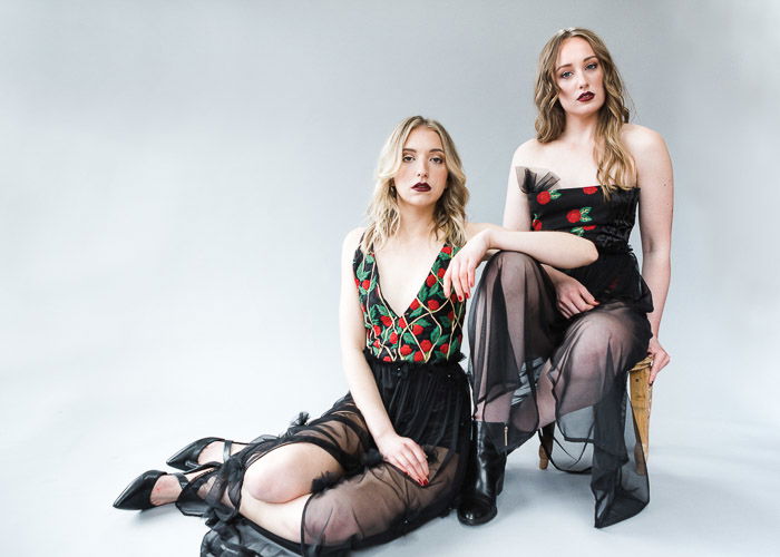 Two female models posing in a photography studio