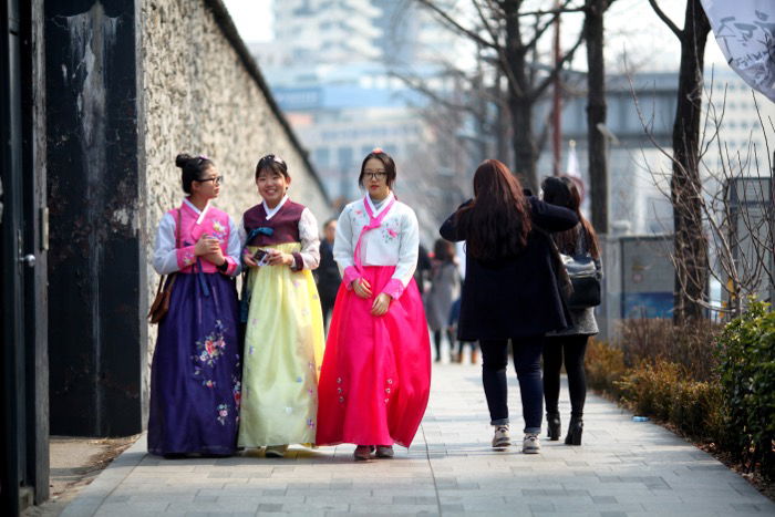 street photography showing three South Korean girls wearing traditional clothing known as Hanbok