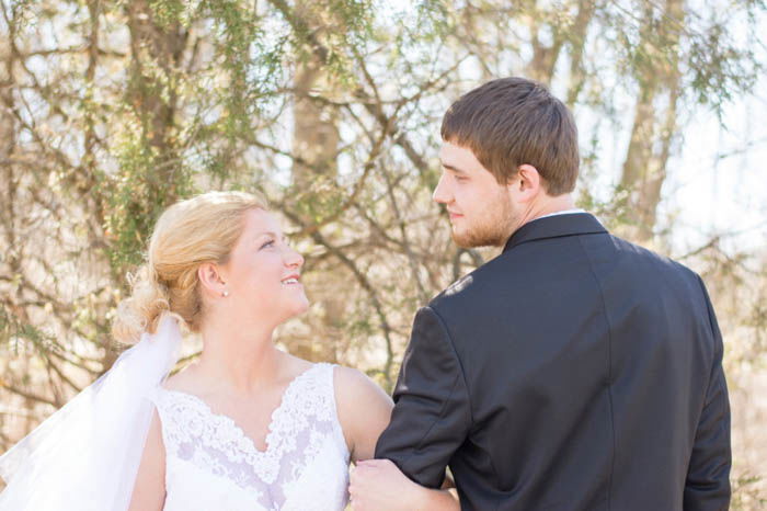 Bride and Groom wedding pose arm in arm outdoors