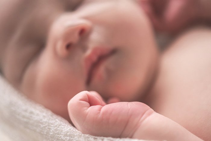 A close up portrait of a baby taken with a camera for newborn photography