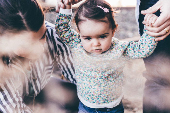 lifestyle family photography of a couple with a little girl