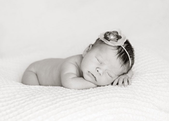 Look for creamy skin tones by keeping the contrast down during the post-processing of your newborn photography