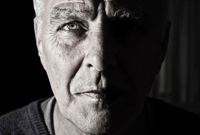 Black and white close up portrait of an old man