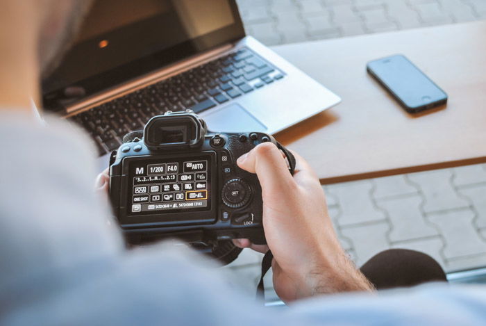 A photographer changing camera settings