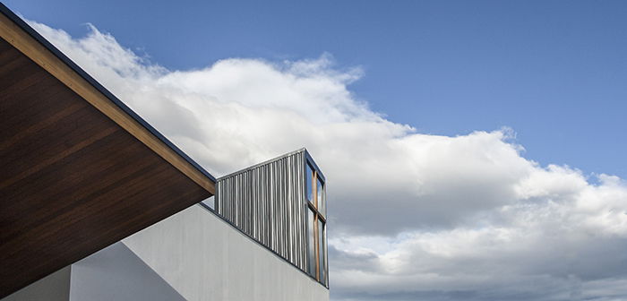 Details of Christchurch North Methodist Church against a cloudy blue sky taken with a wide angle lens