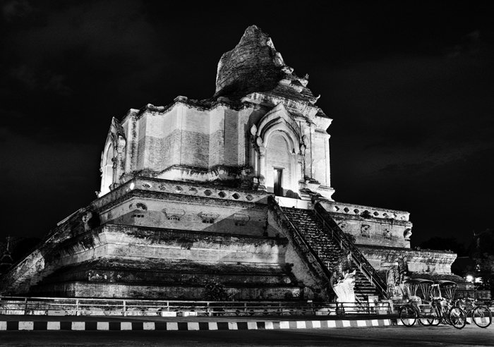 Black and white travel photography of Chiang Mai's Wat Chedi Luang at night.