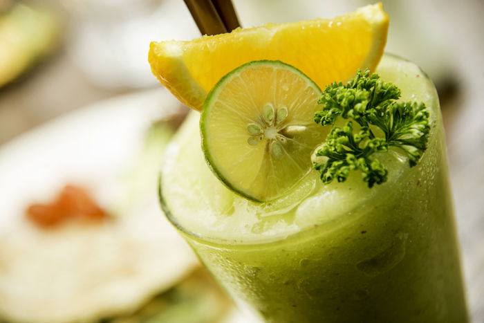 A close up of a green cocktail drink in colour