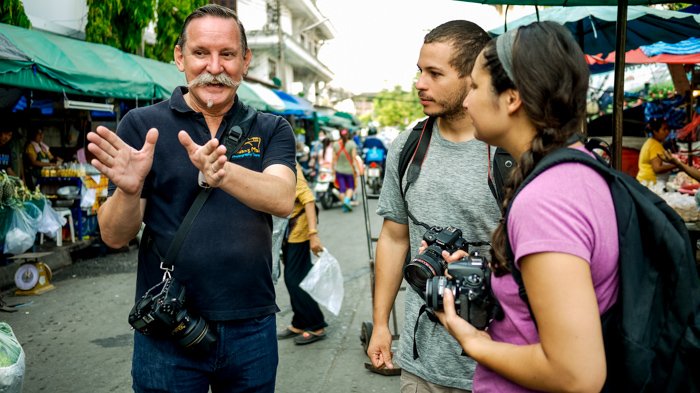 Documentary photography portrait of a photography workshop in a Market in Chiang Mai, Thailand.