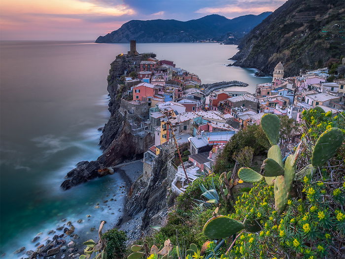 Long-exposure photography of a coastal town and seascape in Italy.