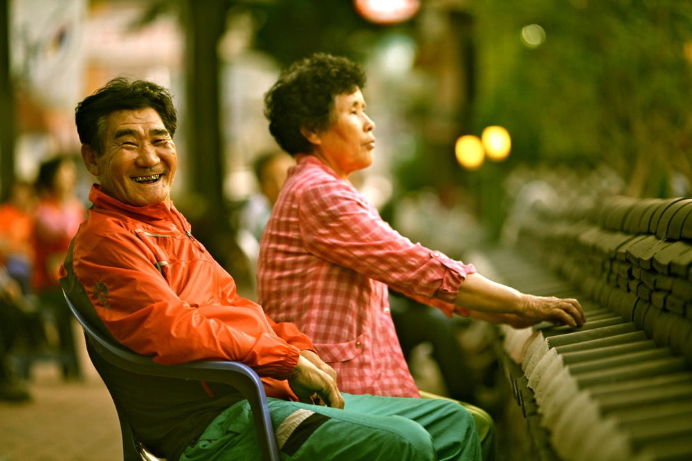 Street Photography of a man and woman sitting outdoors.