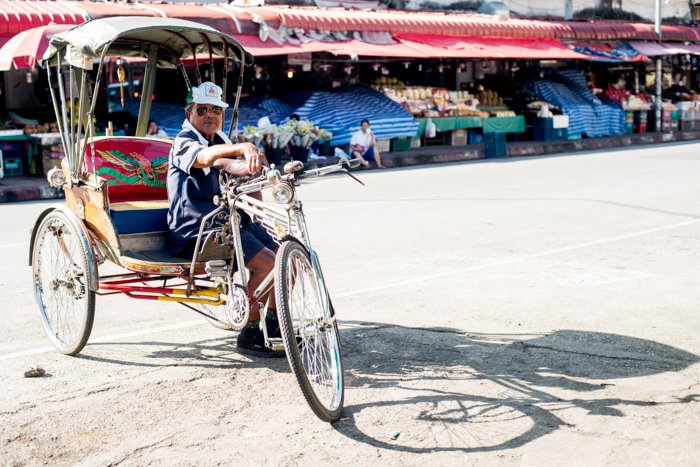 saamlor driver in a market in Chiang Mai, Thailand