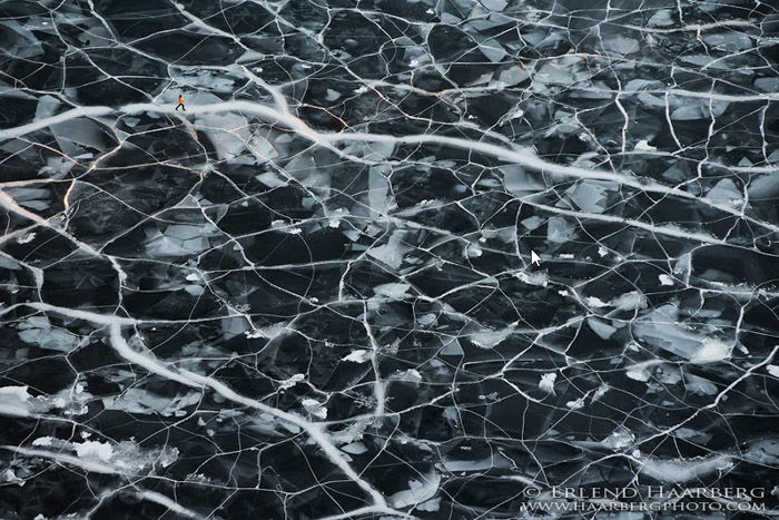 Photo of a figure walks through a textured icy landscape by Erlend & Orsolya Haarberg. 