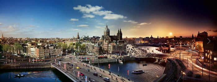 Stephen Wilkes panorama of a city showing the transition from night into day. 