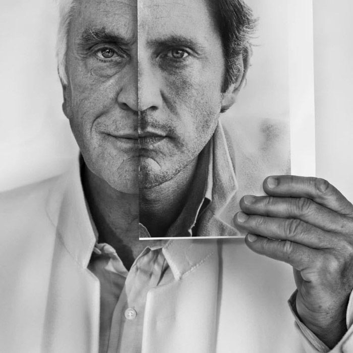 A photograph of Terence Stamp holding a photograph of his younger self juxtaposed on his face