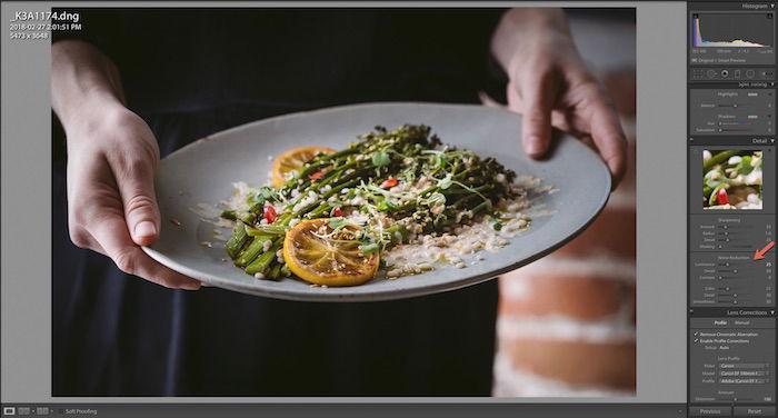 Shot of Adobe Lightroom interface editing a close up of a person holding a plate of salad.