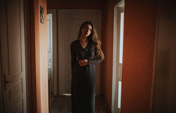 indoor portrait of a girl in long grey dress - natural light portrait photography