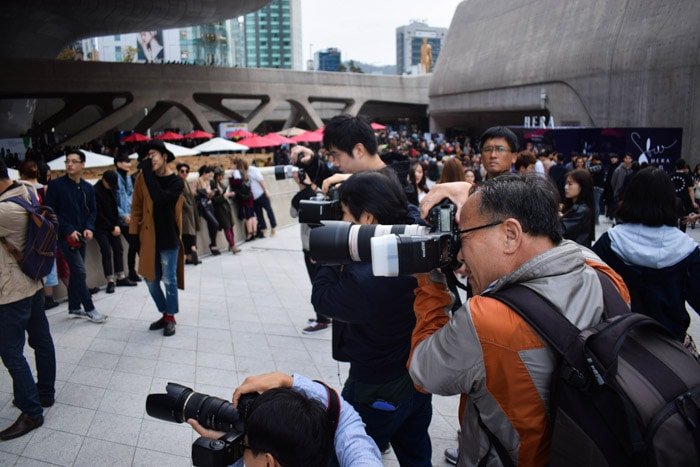 Street photography of a group of media photographers. 