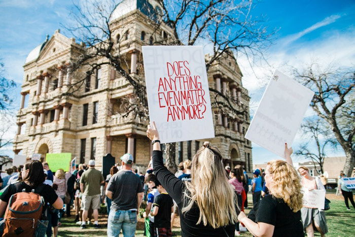 Street photography of a group of people protesting. 