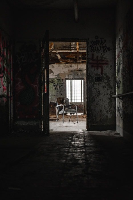 Atmospheric and dark photo of the interior of an abandoned building as part of a photo-essay