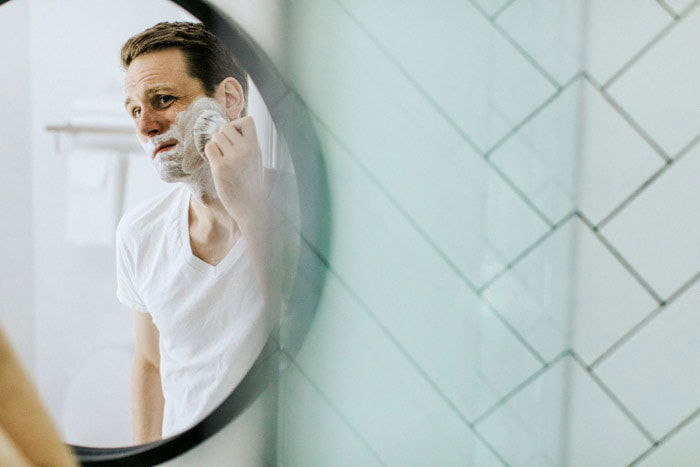 Portrait photography of a man shaving in the mirror. Photo essay examples.