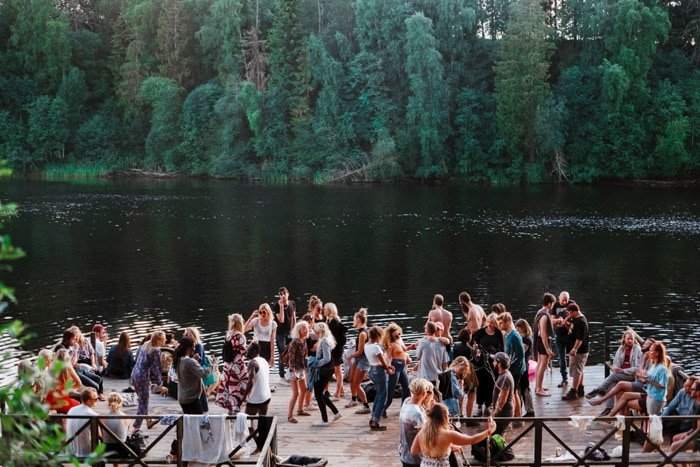 Documentary photography essay of a group of people at an event by a lake. 