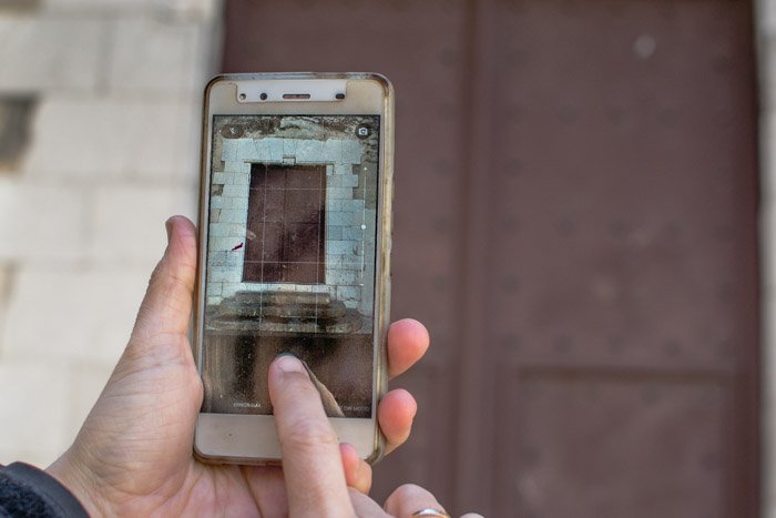 Using a smart phone to photograph a window frame on a photography walk