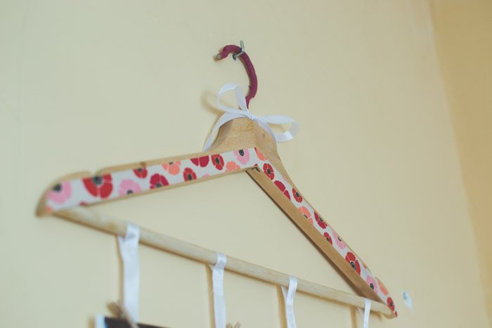 A painted wooden clothes hanger on the wall. Creative Photography ideas.