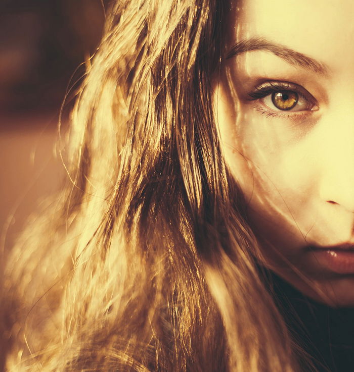 Close up portrait of a dark haired girl with a bokeh background