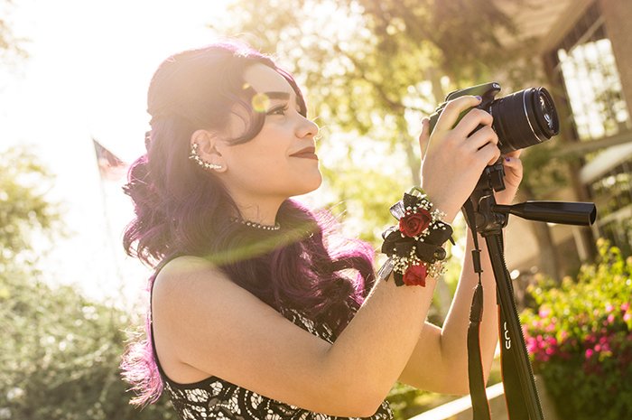 Bright and airy portrait of a girl holding a camera on a tripod. Self portrait ideas