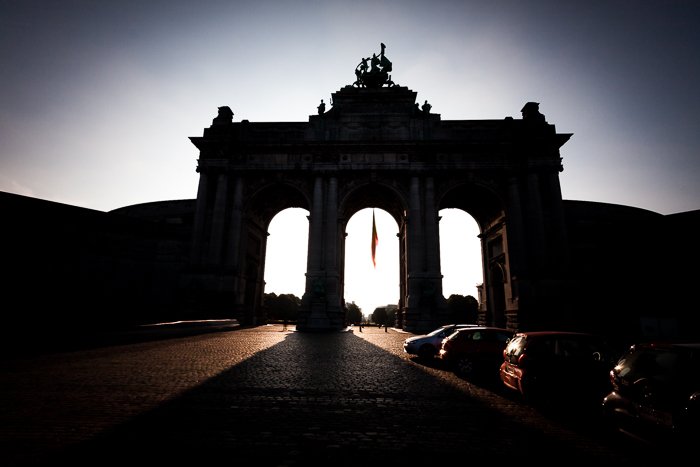 Dramatic shadowy front view photograph of the Arc du Cinquantenaire in Brussels. urban photography
