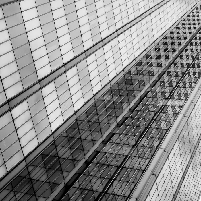 The multiple reflections playing together create a checked pattern on this building's facade.