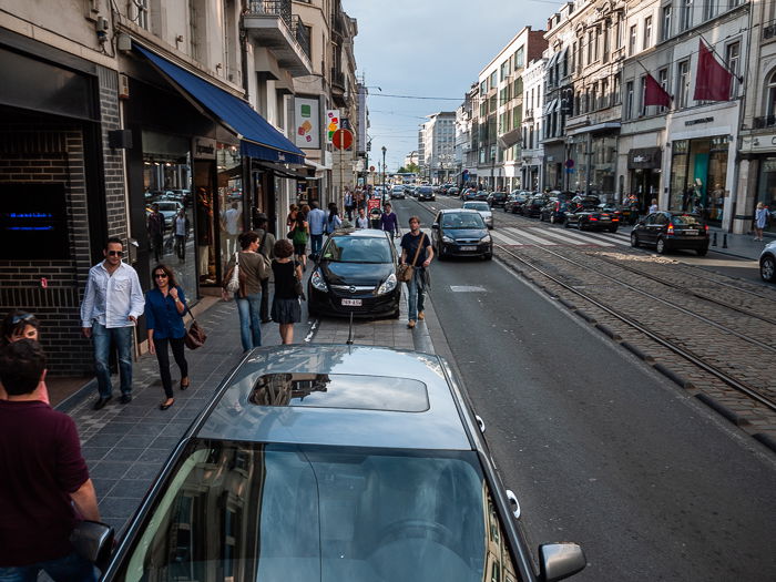 a busy urban street scene, raised viewpoint achieved by mounting Panasonic GF-2 mirrorless camera on a monopod