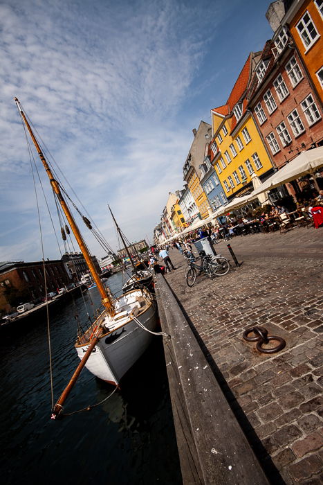 tilted composition photo of the colourful houses, the channel and the restaurants at the Nyhavn canal in Copenhagen