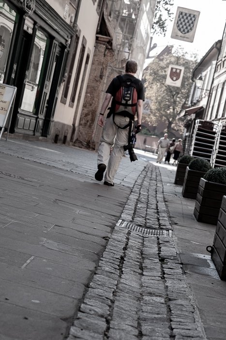 low angle view of a man walking away from the camera in the streets of Strassbourg. Urban photography
