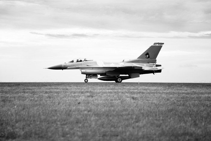 Black and white airshow photography of a plane on the runway