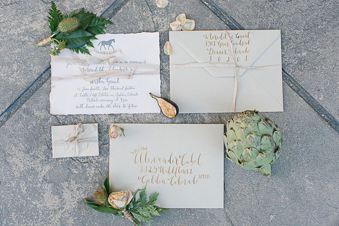 Personalized wedding invitations displayed on stone