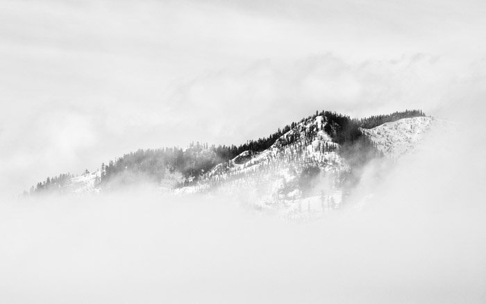 Atmospheric misty and snowy mountainous landscape - tone and weight balance in photography