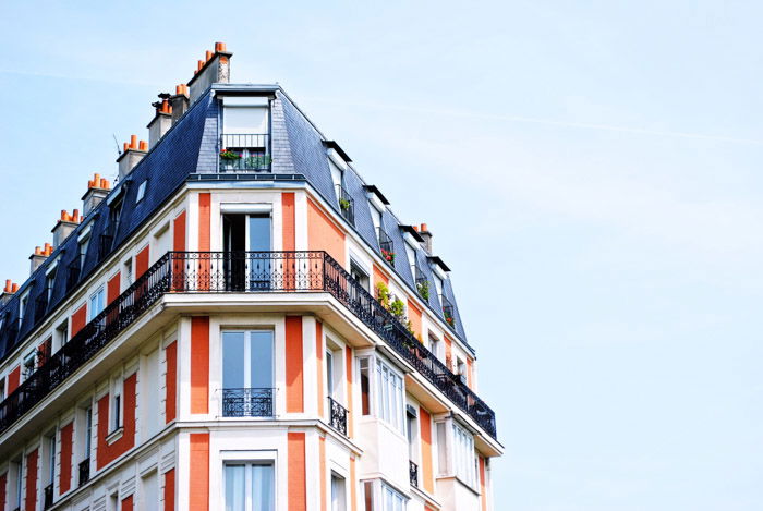 Top of a colorful multi windowed building demonstrating asymmetrical weight balance in photography