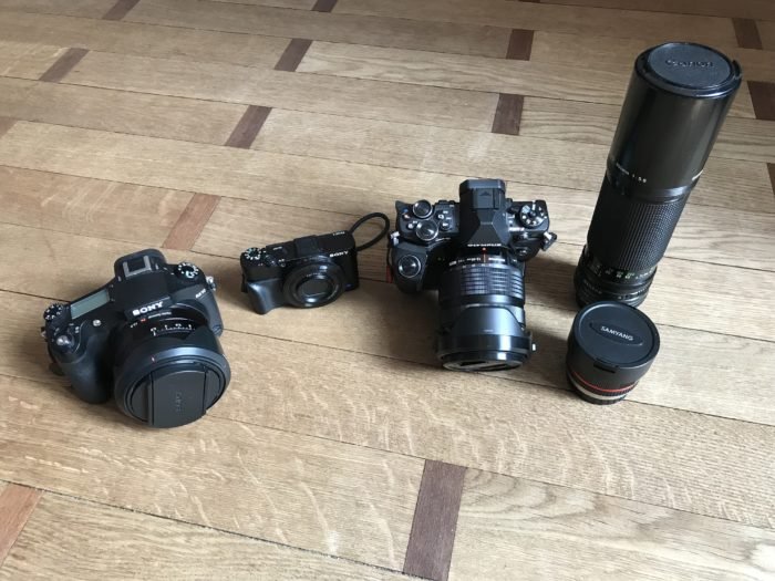 Shot of a Sony RX10 (left), Sony RX100 Mk ii (center) and Olympus OM-D EM-5 Mk II + a couple of lenses (right). 
