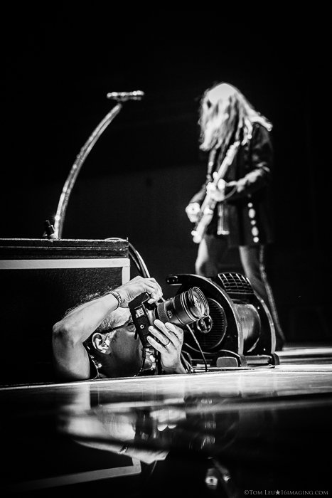 black and white photo of a freelance photographer shooting a concert