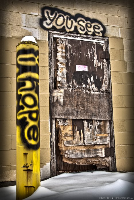 a street photography shot of a doorway with graffiti above, freelance photography tips