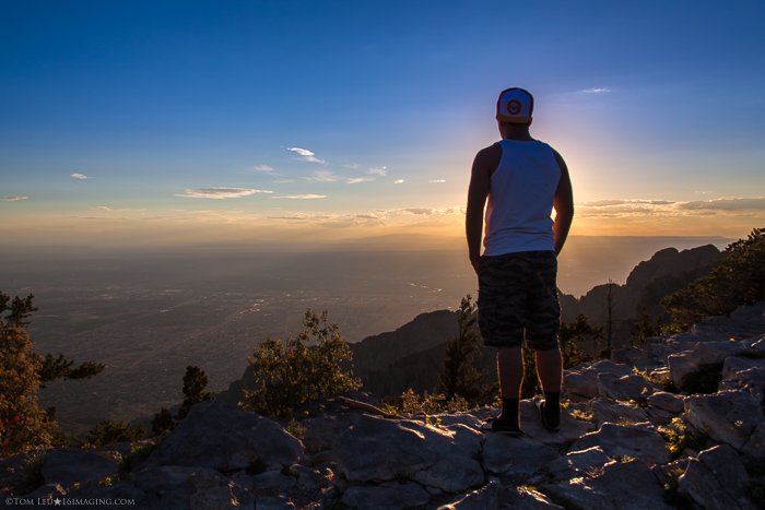 A portrairt of a man standing on the edge of a cliff at sunset - tips for starting in Freelance photography