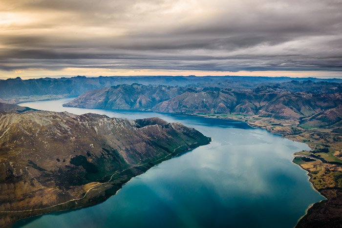 Breathtaking aerial landscape shot of mountains and a river - travel photography jobs 