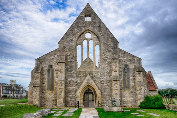 An old church against a cloudy blue sky - travel photography jobs 