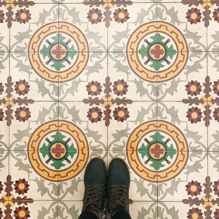 Overhead photography of a patterned floor and the photographers feet processed with VSCO with c3 preset. Instagram tips for social media photography.