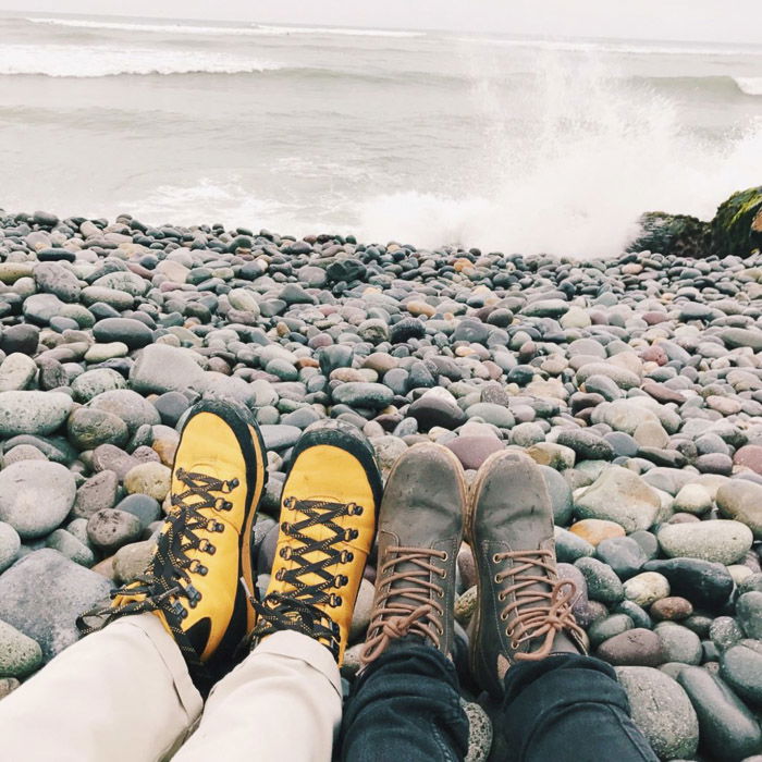 Beach landscape shot with two peoples feet in the foreground. Instagram tips for photography beginners.