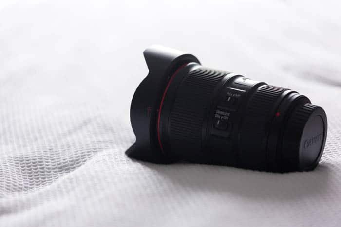 A camera lens with a lens hood attached