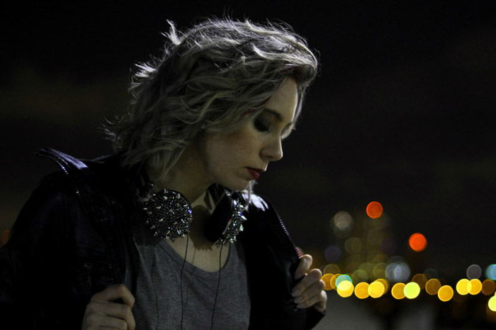 A female poses at night fashion model photography shoot.