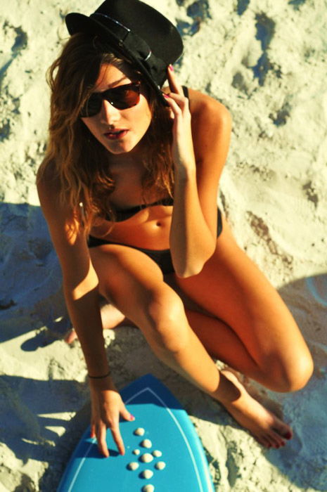 A female poses on a beach for fashion model photography