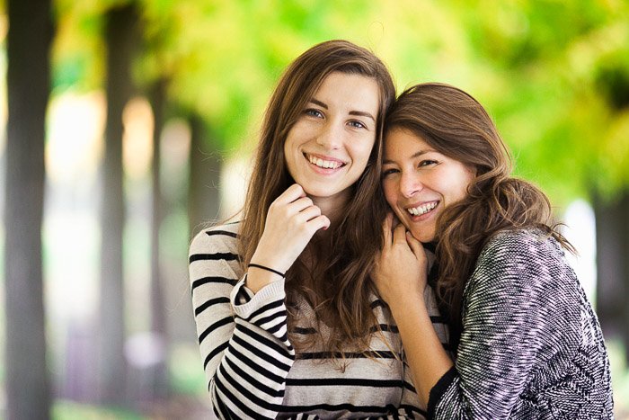 An outdoor portrait of two female friends hugging casually in Brühl, Germany 